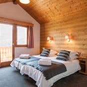 Chalet Charmille's top floor spacious quad room 1, with adjoining annex sleeps 3/4, ensuite with balcony and lovely views.